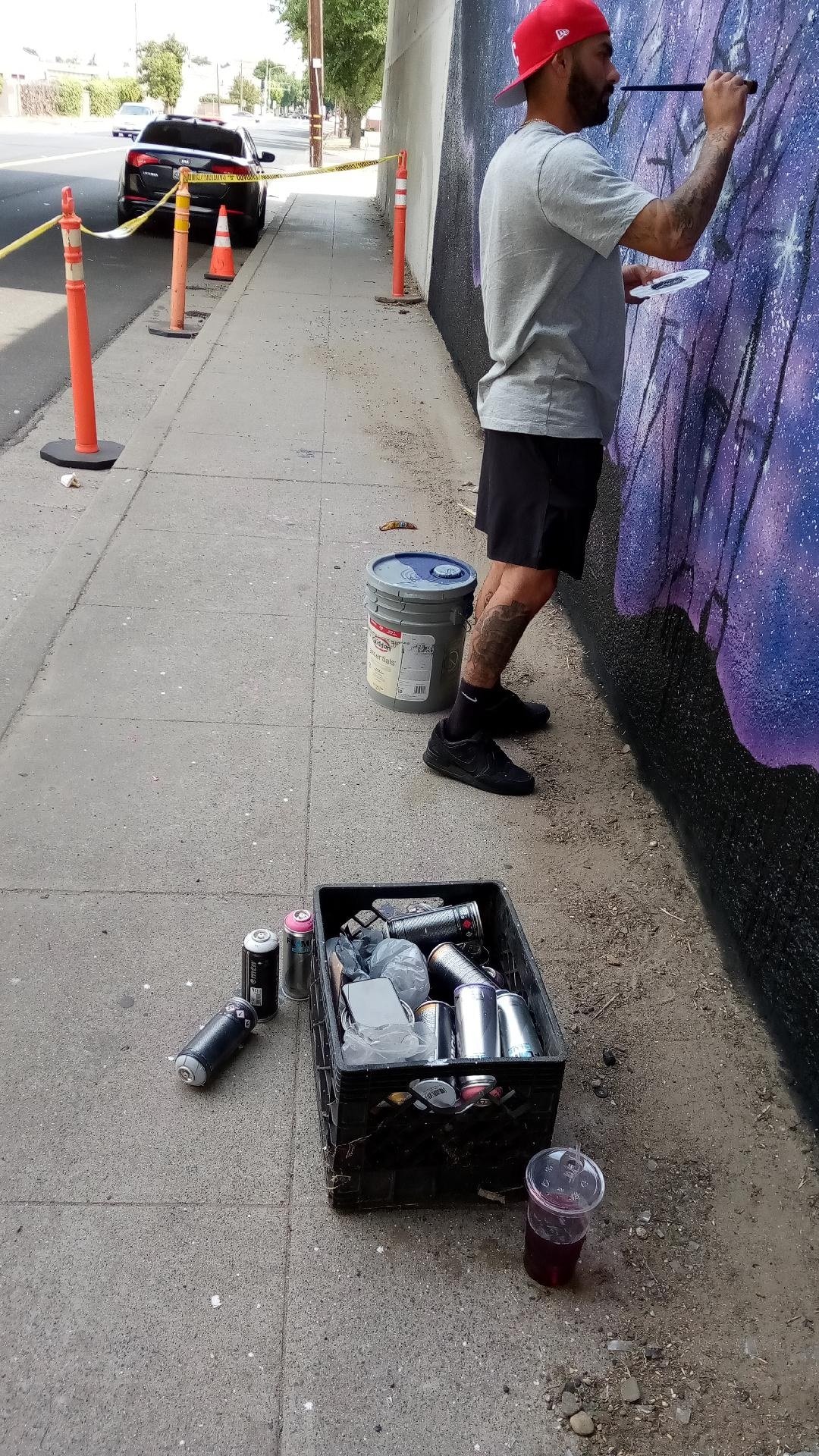  This box full of spray paint cans is used by Martin as he creates his mural beneath the highway 99 overpass at Canal Street. Photo: Steve Newvine 