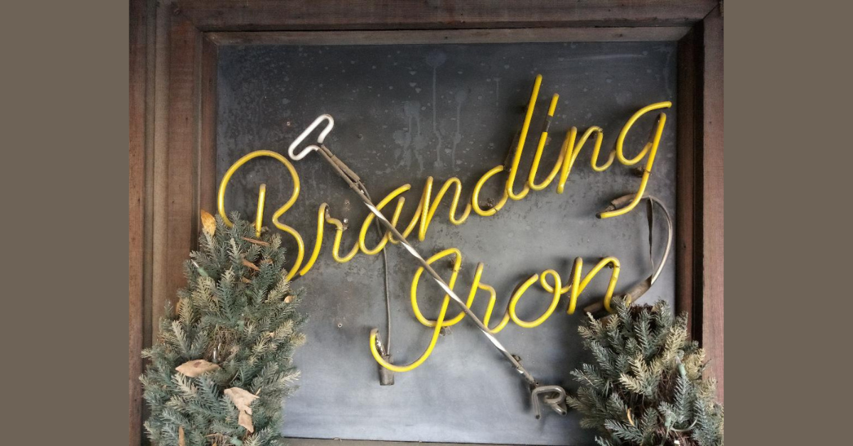    A smaller neon sign welcomes visitors to the Branding Iron entrance.  Photo:  Steve Newvine 