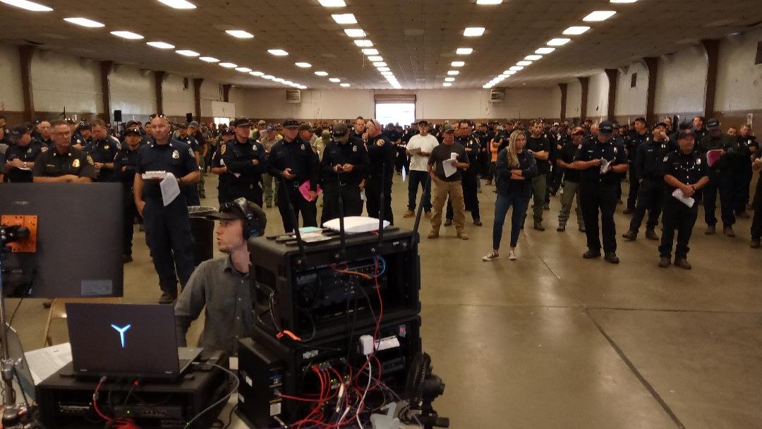  Several hundred Cal-Fire personnel  are watch, listen, and take notes at the daily Incident Report meeting for the Oak Fire .  Photo:  Steve Newvine 