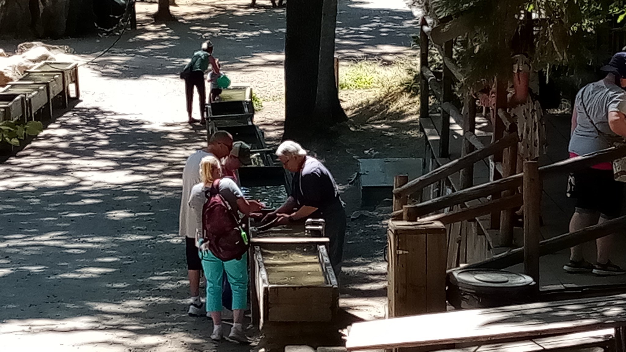 A worker helps visitors pan for gold at the prospector’s shop in the Columbia Historic State Park. Photo: Steve Newvine